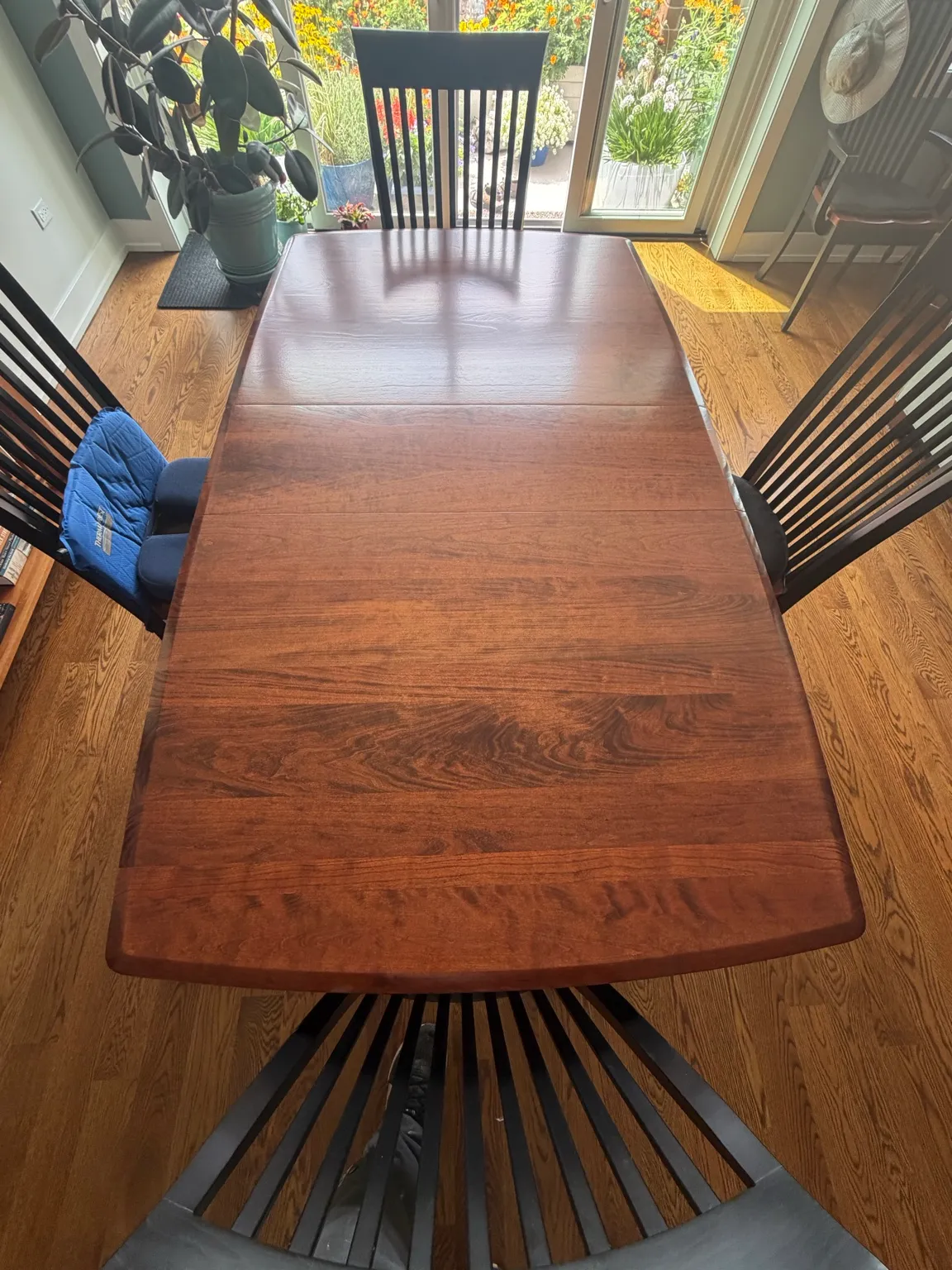 Finished rectangular wood dining table with a rich brown surface